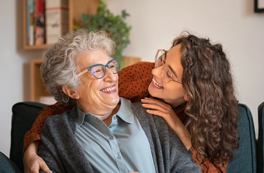 A younger person embracing an older person